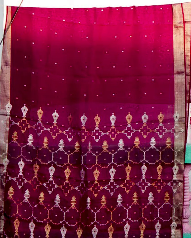 A magenta Chanderi sari at full length, gold butis scattered across the body.