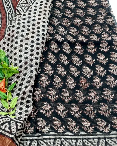 A Kota doria dupatta in black and cream block print, its square-check weave open to the light.