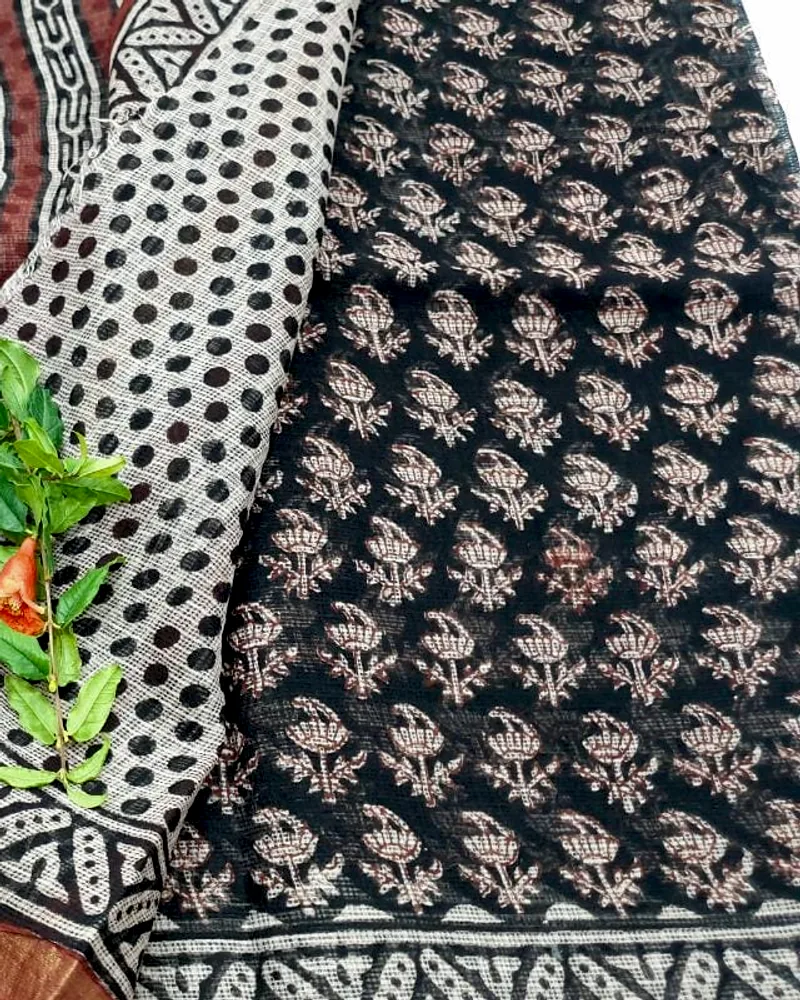 A Kota doria dupatta in black and cream block print, its square-check weave open to the light.