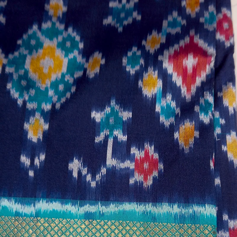 Pochampally ikat in indigo, its stepped diamond motifs feathering where warp meets weft.