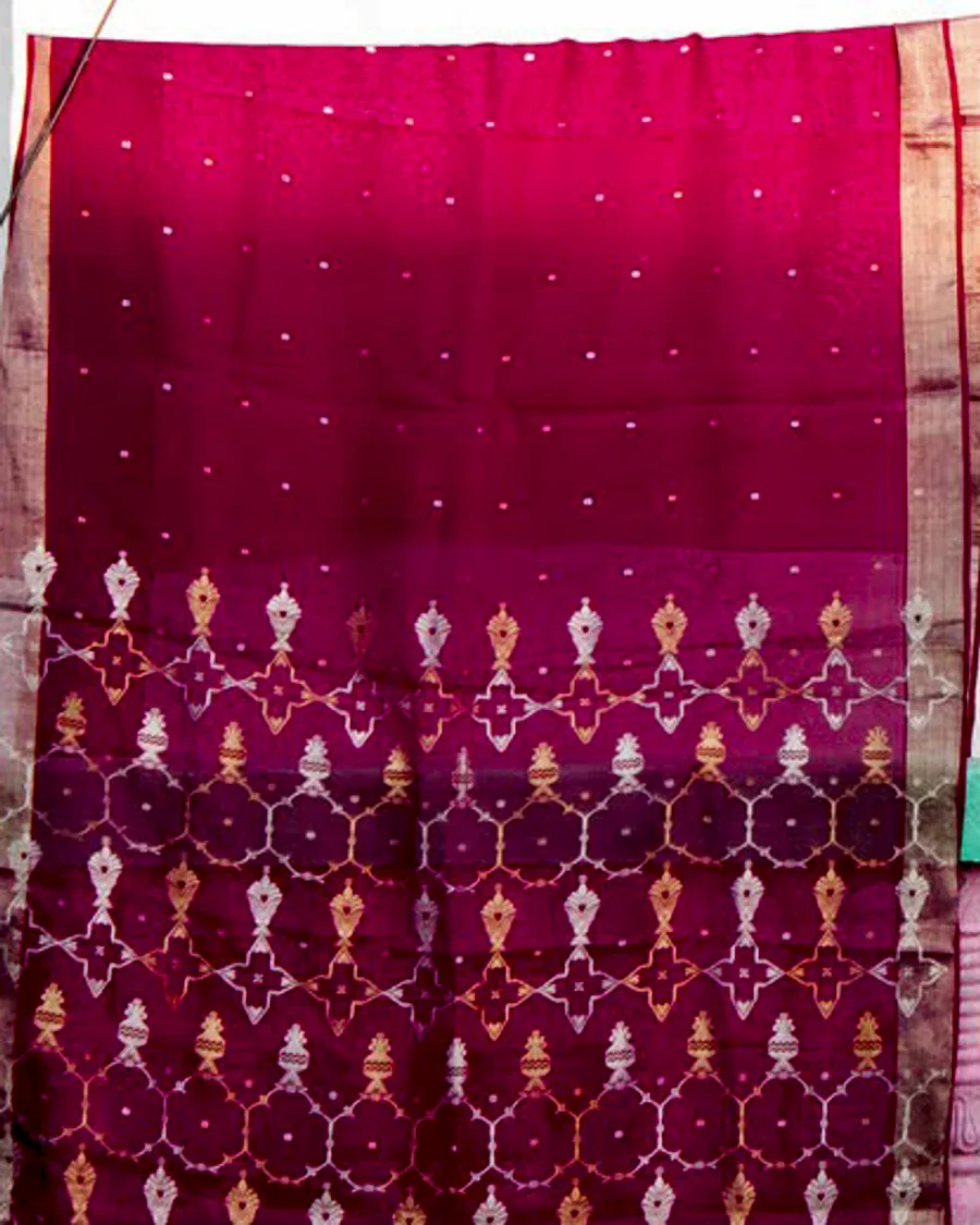 A magenta Chanderi sari hung to air outside a village house near Chanderi.