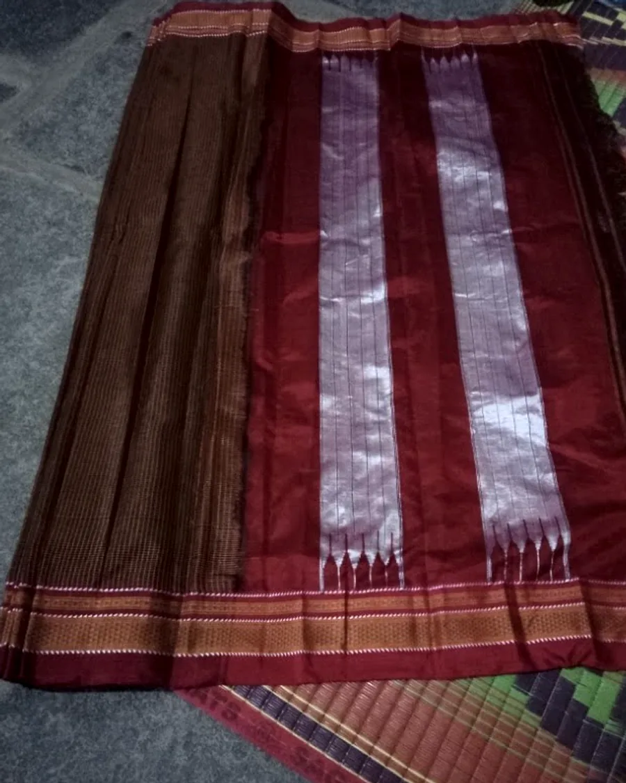 An Ilkal sari opened out, its bronze striped body running into a red silk pallu.